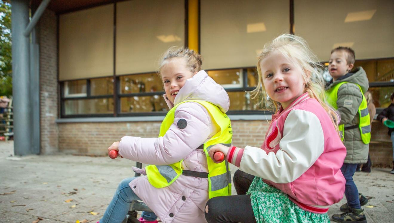 Kinderen met en zonder handicap samen aan het spelen op een schoolplein